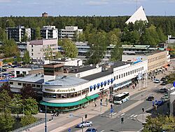 Ahjo building from 1935 in central Hyvinkää. The church of Hyvinkää in the background.