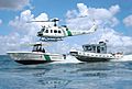 Office of CBP Air and Marine helicopter and boats