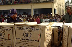 US Navy 071203-N-1831S-159 Boxes of relief supplies are piled near Bangladeshi citizens affected by Tropical Cyclone Sidr.jpg