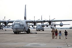 A U.S. Marine with Marine Aerial Refueler Transport Squadron (VMGR) 252 and his family share a final moment together while walking toward a KC-130J Hercules aircraft at Marine Corps Air Station Cherry Point 130717-M-OT671-061.jpg