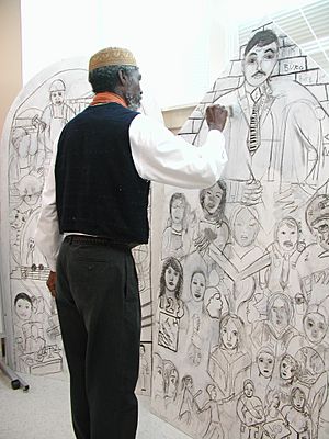 Artist TJ Reddy works on a mural in Charlotte, N.C