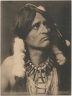 Man in feathered Indian headdress