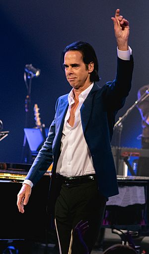 Nick Cave performing to the side of the camera