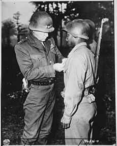 "Lt. Gen. George S. Patton, U.S. Third Army commander, pins the Silver Star on Private Ernest A. Jenkins of New York Cit - NARA - 535724