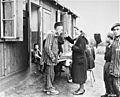 A sick Polish survivor in the Hannover-Ahlem concentration camp receives medicine from a German Red Cross worker