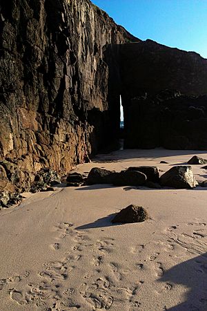 Southern edge of Nanjizal beach with Zawn Pyg rock arch in the background August 2013
