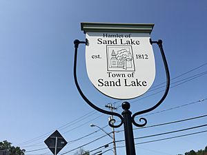 2017-09-10 12 28 14 Sign for the Hamlet of Sand Lake in the Town of Sand Lake at the intersection of New York State Route 43 and New York State Route 66 in Sand Lake, Rensselaer County, New York