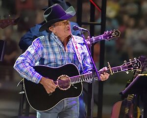 A photo of George Strait playing a guitar