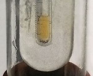 Small sample of pale yellow liquid fluorine condensed in liquid nitrogen