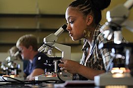 Southern Arkansas University Biology student with microscope