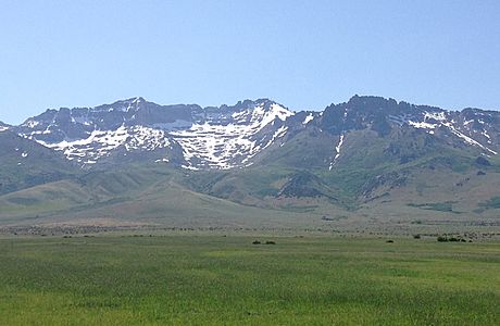 2014-06-11 15 27 42 View west towards Hole in the Mountain Peak from Nevada State Route 232 (Clover Valley Road) 6.1 miles north of the southern terminus in Clover Valley, Nevada-cropped