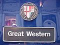 A black nameplate stating "Great Western" with a multi-coloured shield above.