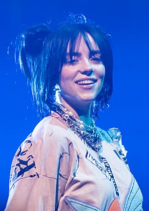 Eilish smiling while looking at a camera