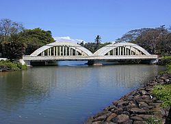 Historic twin-span "Anahulu Bridge" over the Anahulu River marks the north end entrance to old Haleʻiwa Town