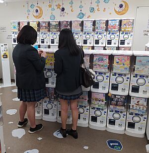 Japanese schoolgirls at gashapon