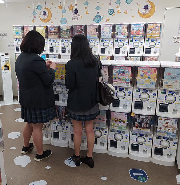 Japanese schoolgirls at gashapon