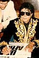 Michael Jackson autographing 'We Are The World' posters 1985