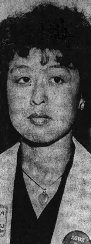 Black and white photograph of Zia wearing a light-colored jacket over a dark-colored shirt and a necklace
