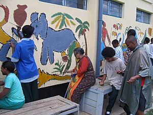 Shanu Lahiri painting a mural in Rwanda