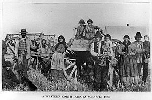Metis family with Red River carts in North Dakota (1883)