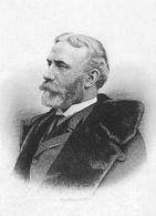 An old man with grey hair and a beard, wearing a suit and overcoat