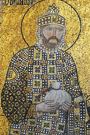 A mosaic with a background of gold showing a bearded Constantine wearing a crown and jeweled robes holding a small bag in his hands which is tied at the top
