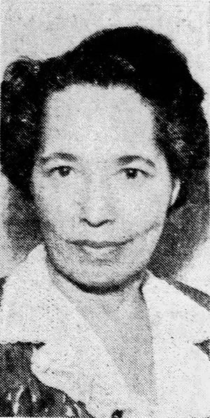 Portrait of an African-American woman with short hair in a printed dress with a wide butterfly-style, white collar
