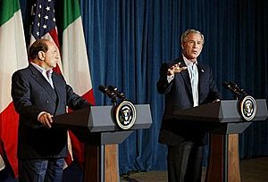 Silvio Berlusconi and George W. Bush, speaking at Crawford, Texas