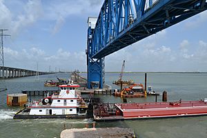 Tug and barge passing under new lift span of Galveston Causeway rail line, viewed from below bridge, Aug. 2012