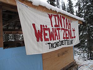 A banner at the Unist'ot'en Camp that says: "Yintah' Wëwat’zenlï-Taking Care of the Land"