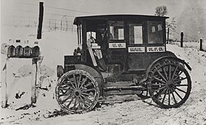 Rural carrier in automobile at mailboxes, c.1910