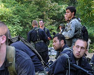 A Special Forces candidate and several role players conduct planning during ROBIN SAGE