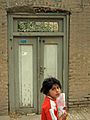 Iranian Nishapuri Elementary schoolgirl with texbook going to her classmate house for study together at evening - Aliov st - Nishapur