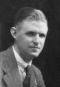 Black and white photograph of a young man wearing a business suit