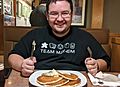 Man about to eat a plate of pancakes