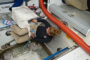 STS-135 Sandy Magnus with a cargo transfer bag