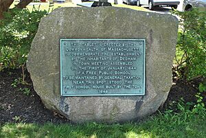 Stone plaque marking the site of the first public school in America