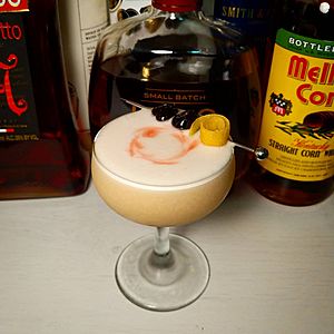 Whiskey sour in coupe glass with garnishes