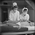 Poston, Arizona. Registered nurse, Mrs. Edythe Sasser, is assisited by Yoshiko Konatsu, nurse's aid . . . - NARA - 537104