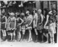 11 women and a little girl lined up for bathing beauty contest