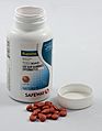 Bottle of Ibuprofen tablets with cap removed and tablets in front