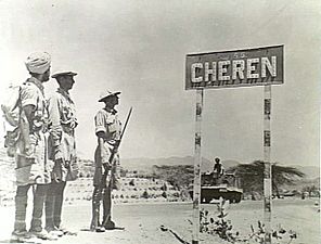 Indian troops stand next to a Cheren (Keren) signpost, May 1941