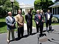 President George W. Bush speaks to reporters with NCAA head football coaches
