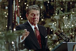 President Ronald Reagan speaking at a podium during his final press conference in the East Room