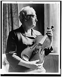 An expert on the violin, Dr. Apgar examines an instrument fashioned from an old telephone shelf. LCCN2002712241