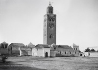 black-and-white photo of the mosque and its minaret-tower, seen from ground level