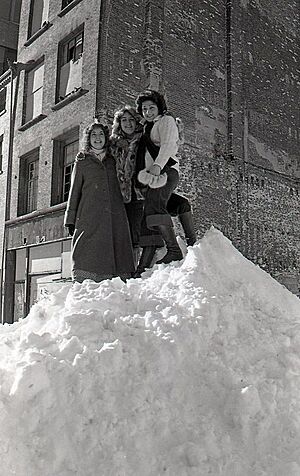 Women on top of snow drift near City Hall (16186848000)