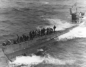 A U.S. Navy boarding party working to secure a tow line to the bow of the captured German submarine U-505, 4 June 1944 (80-G-49172).jpg
