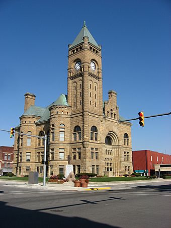 Old courthouse featuring clock tower and turrets