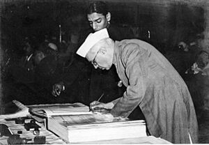 Jawaharlal Nehru signing Indian Constitution